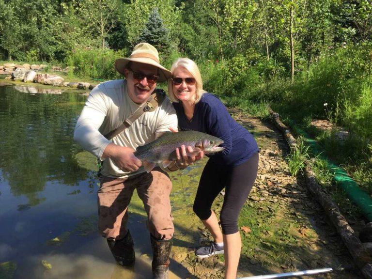 Clare Lyons and guest with rainbow,Mountain water adventures, fly fishing, musky fishing wv, fly fishing wv, fly fishing for musky, native trout, group trip fly fishing, trout fishing wv, musky on a fly, rainbow trout wv, spring fed fly fishing streams, brown trout wv, golden trout wv, certified fishing guide, certified fishing guide wv, wv, west Virginia, private water fly fishing, west Virginia fly fishing, private fly fishing, private land fly fishing, Monroe County WV, Greenbrier County WV, stream restoration, restored fly fishing stream, Greenbrier, Greenbrier resort, White Sulphur Springs, fly casting instruction, James Crews, Clare Lyons, Second Creek, Drop Lick Creek, the New River, Lazy River, fly fishing gear,fly fishing WV guided fly fishing on miles of private water in southeastern West Virginia. Water and fish you have to experience to believe.