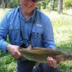fiaherman and trout,Mountain water adventures, fly fishing, musky fishing wv, fly fishing wv, fly fishing for musky, native trout, group trip fly fishing, trout fishing wv, musky on a fly, rainbow trout wv, spring fed fly fishing streams, brown trout wv, golden trout wv, certified fishing guide, certified fishing guide wv, wv, west Virginia, private water fly fishing, west Virginia fly fishing, private fly fishing, private land fly fishing, Monroe County WV, Greenbrier County WV, stream restoration, restored fly fishing stream, Greenbrier, Greenbrier resort, White Sulphur Springs, fly casting instruction, James Crews, Clare Lyons, Second Creek, Drop Lick Creek, the New River, Lazy River, fly fishing gear